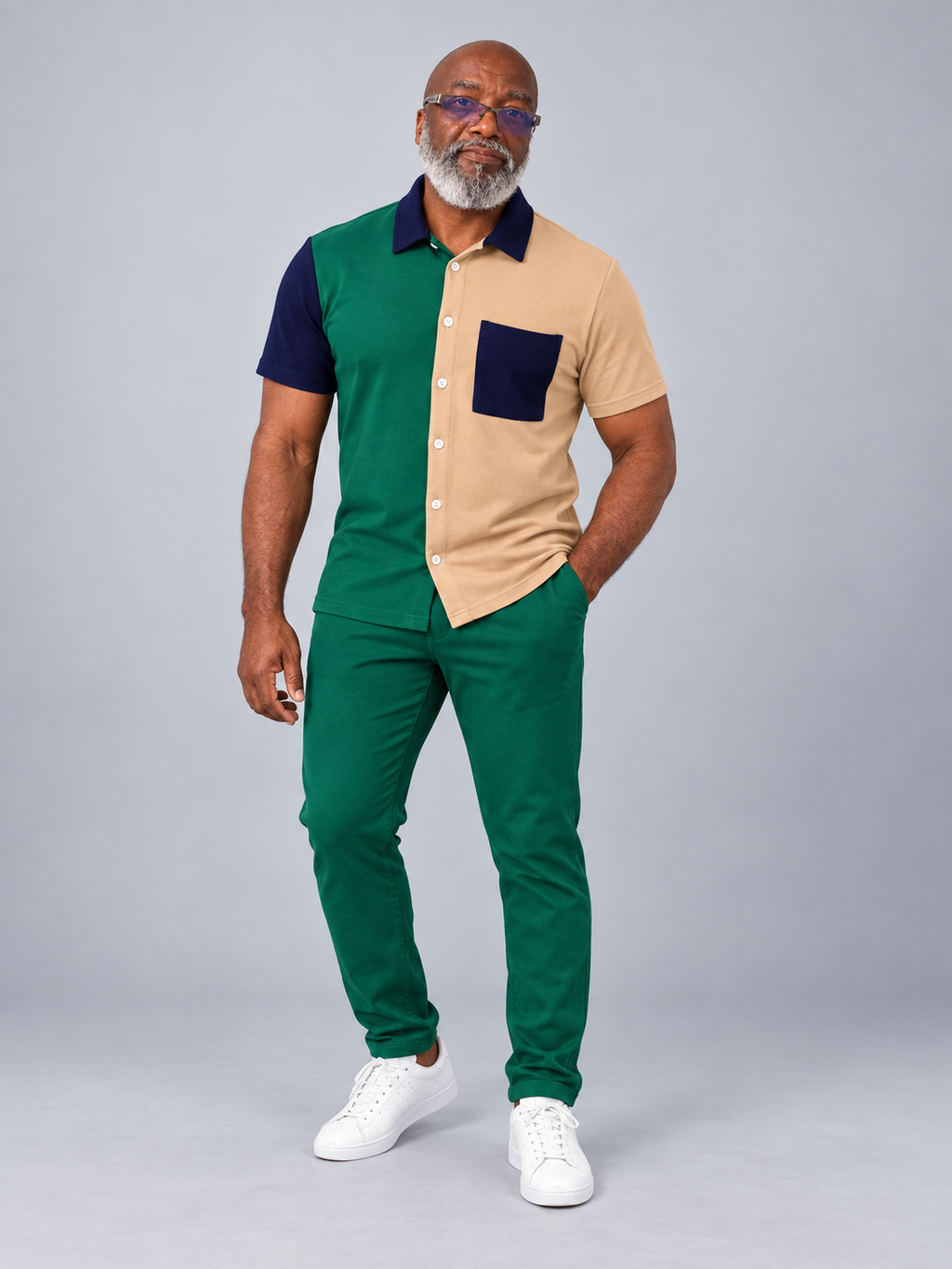 Model wearing green tan and navy color-block short-sleeve shirt with matching green trousers