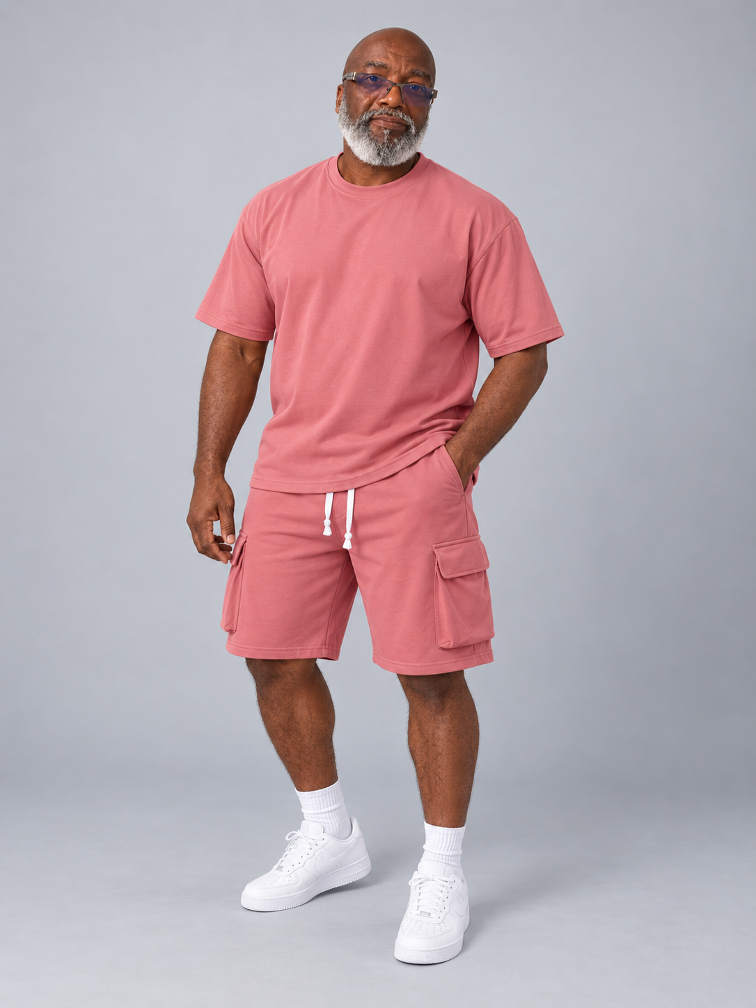 Model wearing the rose pink short sleeve shirt and matching cargo shorts set